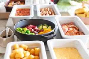 a table topped with bowls of different types of food at Haneda Excel Hotel Tokyu Haneda Airport Terminal 2 in Tokyo