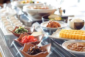 a buffet of different types of food on a table at Haneda Excel Hotel Tokyu Haneda Airport Terminal 2 in Tokyo
