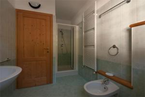 a bathroom with a sink and a toilet and a shower at Residence Le Orchidee in Bormio +46 photos