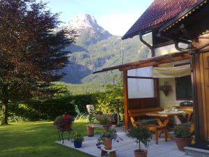 a house with a table and a mountain in the background at Haus Fratnik in Obertraun
