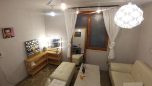 a living room with a couch and a table at Dalbit stay Seodaejeon in Daejeon