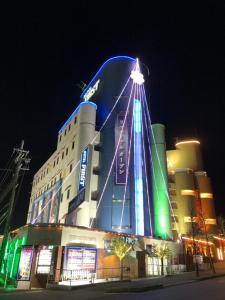 a large building with a blue and green building at Hotel First (Adult Only) in Ikeda