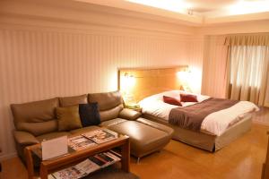 Ένα ή περισσότερα κρεβάτια σε δωμάτιο στο Hotel Coco de Palms & Mer (Love Hotel)