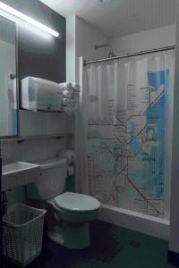 a bathroom with a toilet and a shower curtain at HI Boston Hostel in Boston