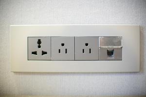 a white lightswitch on a white wall at Savoy Hotel Myeongdong in Seoul