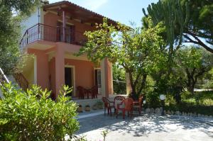 a view of the house from the garden at Anemona Apartments and Studios in Vasilikos
