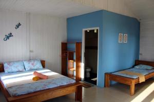 Postel nebo postele na pokoji v ubytování Happy Gecko Dive Resort