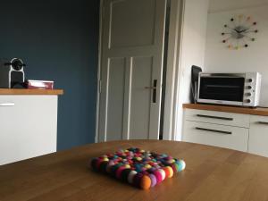 a pile of colorful balls on a table in a kitchen at Les Jardins de l'Ile in Longeville-lès-Metz