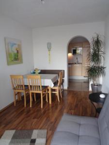 a dining room and living room with a table and chairs at Appartement Auer in Jerzens