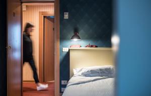 Postel nebo postele na pokoji v ubytování Hotel Torino