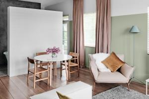 a living room with a table and chairs at The Prince in Melbourne