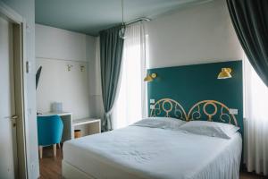 Postel nebo postele na pokoji v ubytování Hotel Torino