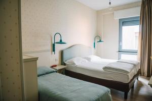 Postel nebo postele na pokoji v ubytování Hotel Torino