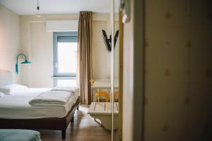 Postel nebo postele na pokoji v ubytování Hotel Torino