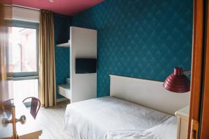 Postel nebo postele na pokoji v ubytování Hotel Torino