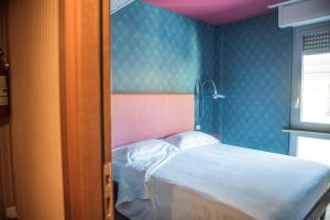 Postel nebo postele na pokoji v ubytování Hotel Torino
