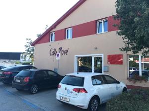 a white car parked in front of a building at Pension Sonnwendgasse in Ternitz