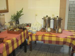 two tables with yellow and red checkered table cloth at Asteri Hotel in Skala