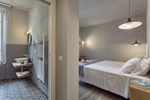 Postel nebo postele na pokoji v ubytování Hotel Torino