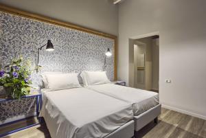 Postel nebo postele na pokoji v ubytování Hotel Torino