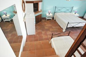 a view of a bedroom with a bed and two tables at La Capasa B&B in Sannicola +17 photos