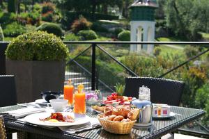 a table with breakfast food on a balcony at Royal Mougins Golf, Hotel & Spa de Luxe in Mougins