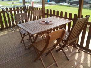 a wooden table and chairs on a wooden deck at eurl de l'écluse in Inor