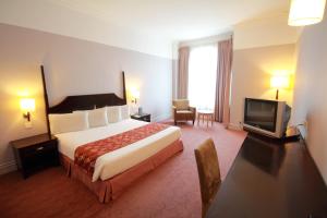 Postel nebo postele na pokoji v ubytování Grand Kampar Hotel