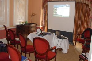 a meeting room with a table and a projector screen at Tower House 1066 in Hastings