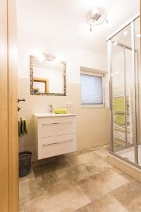 een badkamer met een wastafel en een douche bij Pension Schönberger in Wagrain