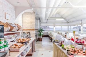 a buffet line with food on display in a restaurant at Exe Domus Aurea in Rome