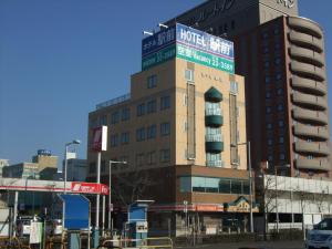 a building with a sign on the top of it at Business Hotel Ekimae in Hakodate