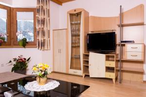 a living room with a tv and a table at Ferienwohnung Eberharter Theresia in Ramsau im Zillertal