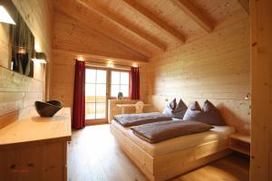 a bedroom with a bed in a wooden room at Almliesl MUEH-512 in Bramberg am Wildkogel