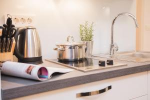 a kitchen counter with a stove and a sink at Residence Teatro in Šibenik +34 photos