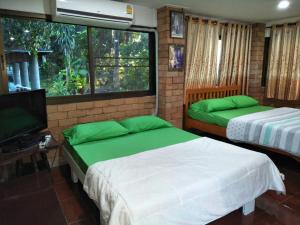 Rúm í herbergi á Oui Kaew Homestay