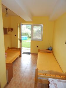 a bedroom with two beds and a door to a yard at Pokoje nad Potokiem in Solina