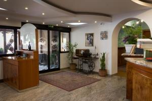 a lobby with a bar with a counter and a table at Albergo Etrusco in Calusco dʼAdda