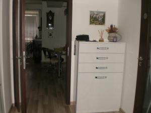a kitchen with a white dresser and a room at AKI - 2 +KK in Brno