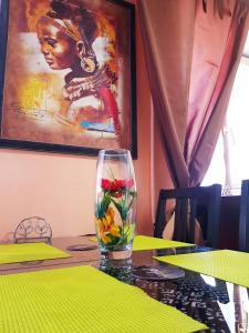 a glass with flowers in it sitting on a table at Apartment Ushakova 16 in Dnipro +16 photos