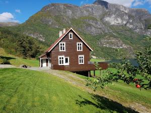 ストリンにあるCharming timber house in Stryn, Norwayの山の前の丘の上の家