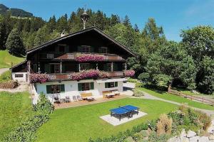 a large house with a picnic table in front of it at Haus Waldhof in Brixen im Thale