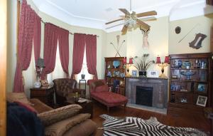 a living room with a couch and a fireplace at 1896 O'Malley House in New Orleans