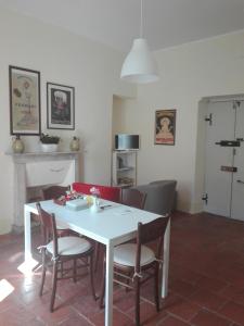 a dining room with a white table and chairs at Casa Ternavassi in Carmagnola