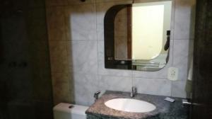 a bathroom with a sink and a mirror and a toilet at Hotel Fênix in Barreiras +30 photos