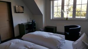 A bed or beds in a room at Hotel Landhaus Feyen