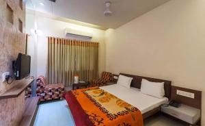 AmbajiHotel Rajmandir的一间有床和电视的卧室 更多17张照片