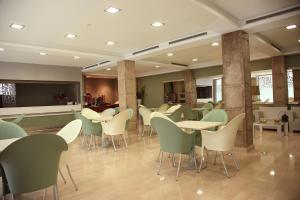a restaurant with tables and chairs in a room at Cesaraugusta in Zaragoza