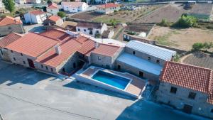 an aerial view of a house with a swimming pool at Casa Mirandês Rural in Miranda do Douro