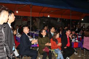 a group of people sitting at tables in a crowd at Moc Chau Town - Homestay in Mộc Châu +63 photos